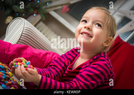 Adorable preschool girl playing with sweets Stock Photo