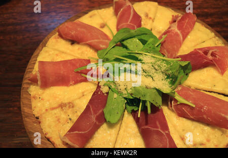 Tasty Parma Ham and Arugula Pizza Serve on Wooden Tray with Selective Focus Stock Photo