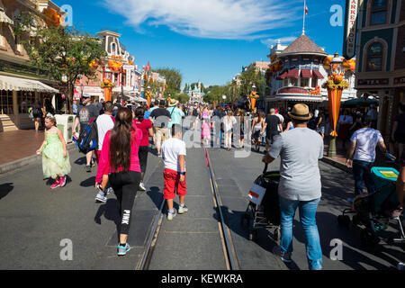 Park guests on a crowded Main Street in front of Cinderella's Castle in ...