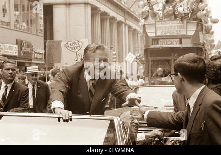 Governor Nelson Rockefeller of New York State, riding in a car on