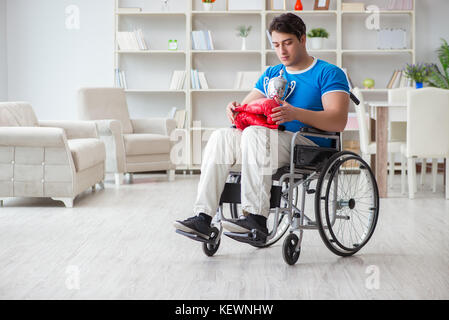 Disabled boxer at wheelchair recovering from injury Stock Photo