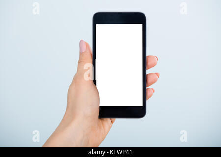 Close-up Of Woman Hand Holding Mobile Phone Showing Blank Screen Stock Photo