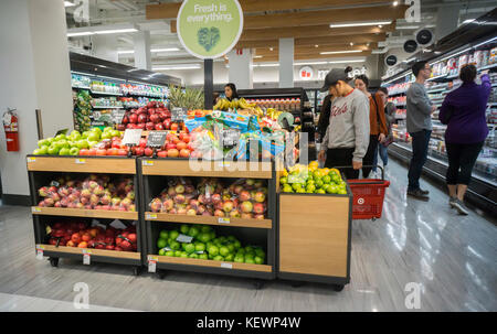 Shoppers in the Market department in a Target store in Herald Square in New York on its grand opening day, Friday, October 20, 2017. The 43,000 square-foot store is Target's 55th small format store. The retail giant is current embarking on a three-year, $7 billion investment in new stores, with smaller footprints, and remodeling of existing stores.(© Richard B. Levine) Stock Photo