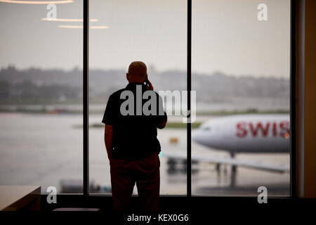 Boston Massachusetts New England North America USA , Logan International Airport  a Swiss airplane pushing back in the rain Terminal E Stock Photo