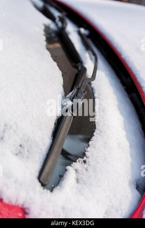 Snow covered car, front winsdshield and wipers detail Stock Photo