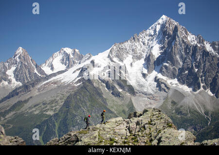 Two mountaineers on a rocky ridge high above Chamonix in the French Alps. Stock Photo