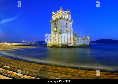 Torre de Belém (Belém Tower), a UNESCO World Heritage Site built in the 16th century in Portuguese Manueline Style at twilight. The River Tagus in the Stock Photo