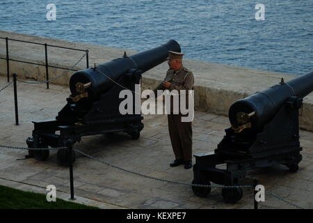 Soldier Firing the Guns at 4pm at the Saluting Battery, Valletta, Malta Stock Photo