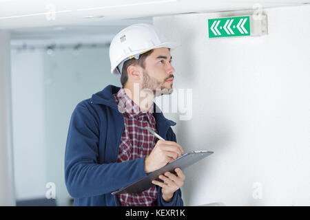 architect checking insulation during house construction Stock Photo