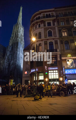 Breakdancer and gathered crowd of audience in street at night, Vienna, Austria Stock Photo