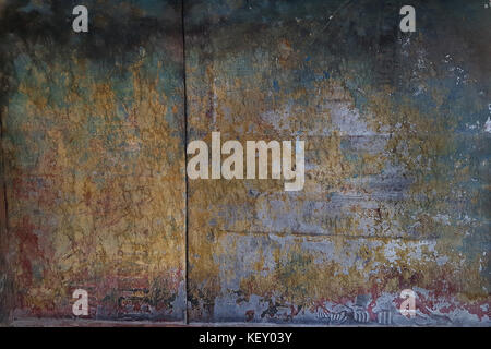Metal sheet yellowish in the middle and noble blue color on the sides, below decorative rust, in the middle empty space for text or picture, modern de Stock Photo