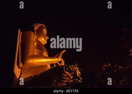 Stutue of golden Buddha by night Stock Photo