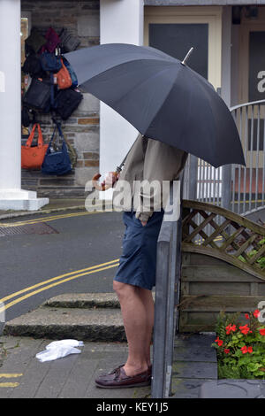 man with umbrella during very heavy downpour, rainstorm in London Stock ...