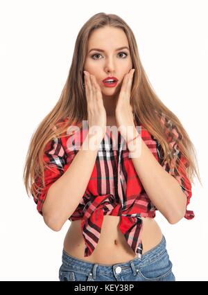 Portrait of surprised amazed attractive young long hair woman wearing checkered top and denim having astonished face expression, covering her open mou Stock Photo