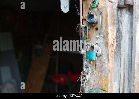 ld shed with accesories hanging on the wall Stock Photo