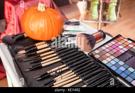 Set of brushes for makeup in a black cover with pumpkin. Halloween making up objects Stock Photo