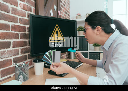confused business woman trying all personal credit card paying but always getting error information let her feeling wrong. Stock Photo