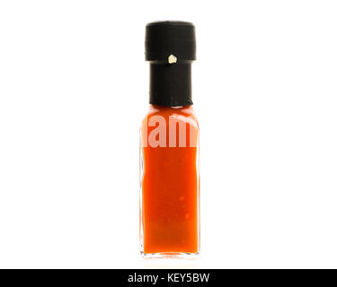 Hot Chili Sauce glass bottle on white background. Different color home made hot sauce in glass bottle.  100ml square bottle. Isolated on white backgro Stock Photo