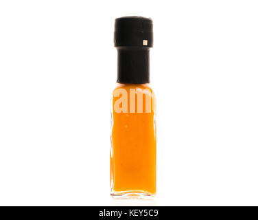 Hot Chili Sauce glass bottle on white background. Different color home made hot sauce in glass bottle.  100ml square bottle. Isolated on white backgro Stock Photo