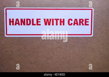 https://l450v.alamy.com/450v/key88d/handle-with-care-sticker-on-cardboard-postal-packaging-key88d.jpg