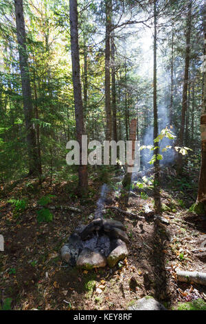 Unattended campfire at a campsite along the Carrigain Notch Trail near EB&L Railroad’s Camp 20 in the Pemigewasset Wilderness, New Hampshire. Stock Photo