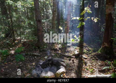 Unattended campfire at a campsite along the Carrigain Notch Trail near EB&L Railroad’s Camp 20 in the Pemigewasset Wilderness, New Hampshire. Stock Photo