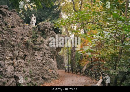 Path in park with marble sculpture on top of hill Stock Photo