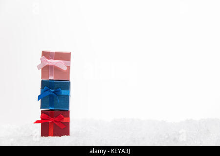 Christmas gifts with snow isolated on white background. Stock Photo
