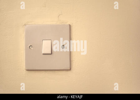 White light switch on interior wall on left hand side of image Stock Photo