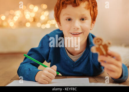 Adorable redhead child drawing on floor Stock Photo