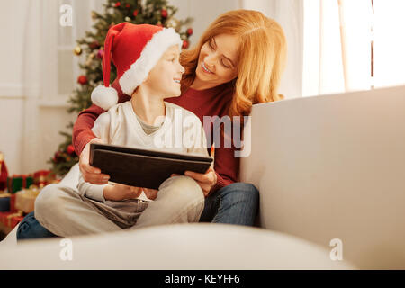 Harmonious family using tablet computer together Stock Photo