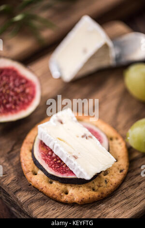 Cheese crackers with camembert and fresh fig. Stock Photo