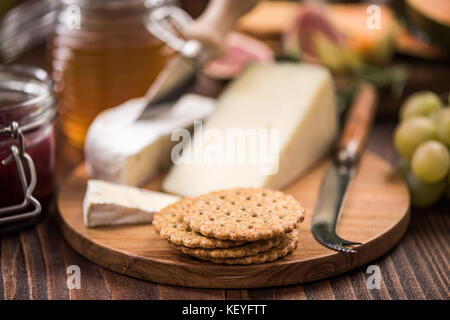 Cheese crackers on board, festive food. Stock Photo