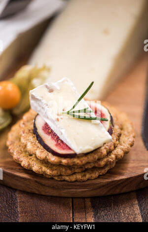 Cheese crackers on board, festive food. Stock Photo