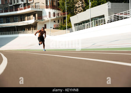 Photo of young african athlete man run on running track outdoors Stock Photo