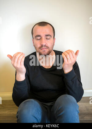 Man praying on white background Stock Photo