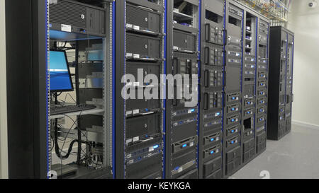 Storage servers are located in the server room of the data center. Back of the server installed in the server room. Many cables are connected to a powerful computers Stock Photo