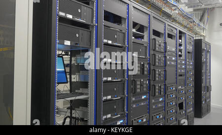 Storage servers are located in the server room of the data center. Back of the server installed in the server room. Many cables are connected to a powerful computers Stock Photo