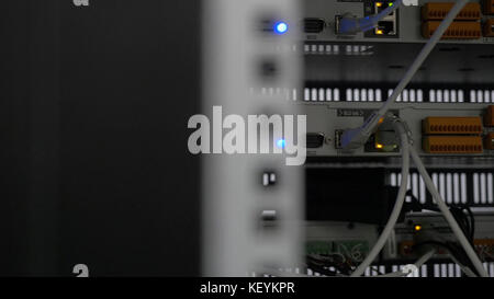 Back of the server installed in the server room. Many cables are connected to a powerful computers. Front panel of the central router. Optical links of a powerful Internet server. Connection of optical Stock Photo