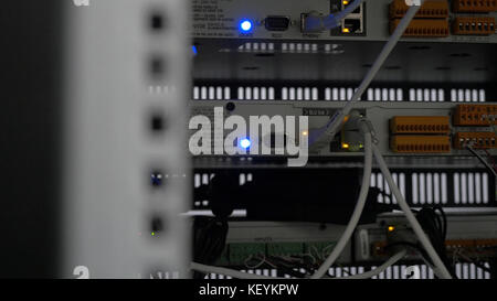 Back of the server installed in the server room. Many cables are connected to a powerful computers. Front panel of the central router. Optical links of a powerful Internet server. Connection of optical Stock Photo