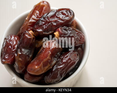 Dates fruit in a plate on wooden background, for ramadan Stock Photo