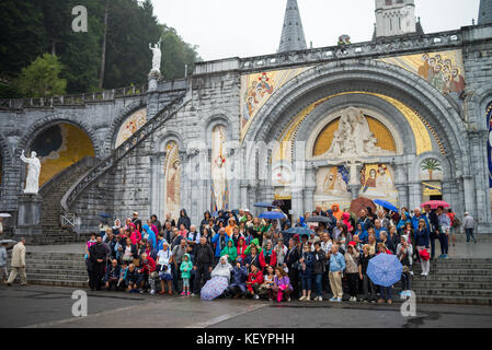 group of tourists in front of the cathedral in Lourdes, France, Europe. Stock Photo