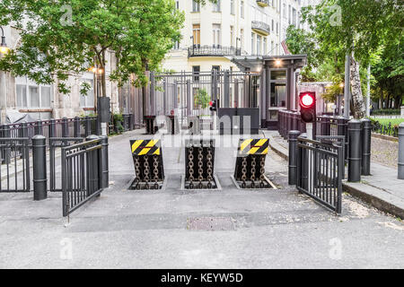 entrance to the underground garage with banning red light and with raised protective devices Stock Photo