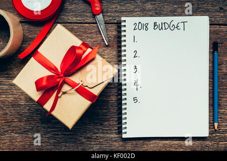 2018 Budget text on notebook paper with gift box. Stock Photo