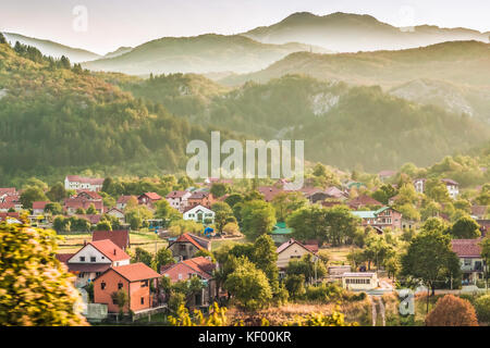 A small village and buildings in the green Balkan mountains of Montenegro. Stock Photo