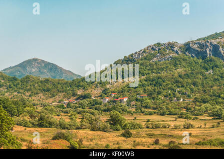 A small village and buildings in the green Balkan mountains of Montenegro. Stock Photo