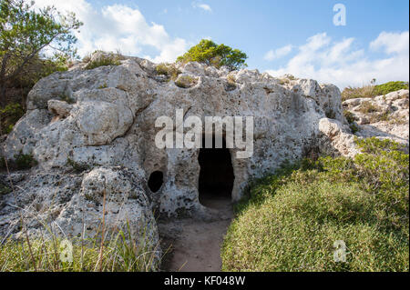 Burial caves in Cala Morell, northern coast of Menroca island, Balearic Islands, Spain, Mediterranean Sea. Stock Photo