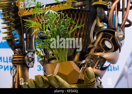 robot metal holds a plant Stock Photo