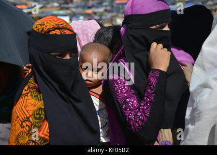 Rohingya women wait for relief aid at the palongkhali makeshift Camp in Cox's Bazar, Bangladesh, on October 06, 2017. Who was injured by gun fire of Stock Photo