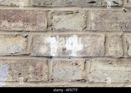 House number 14 sign painted on wall Stock Photo